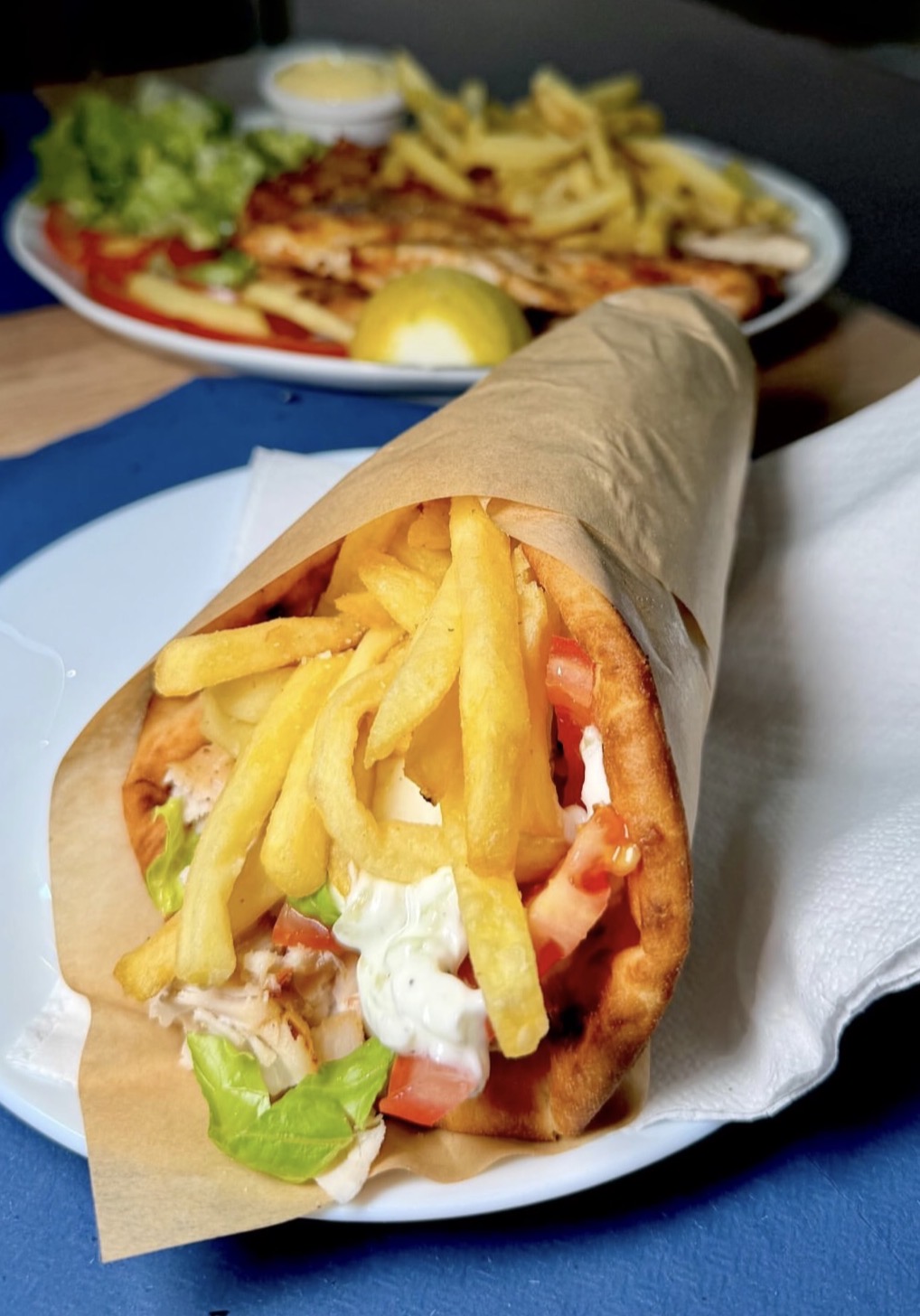 Chicken gyros pita with crispy fries and fresh vegetables